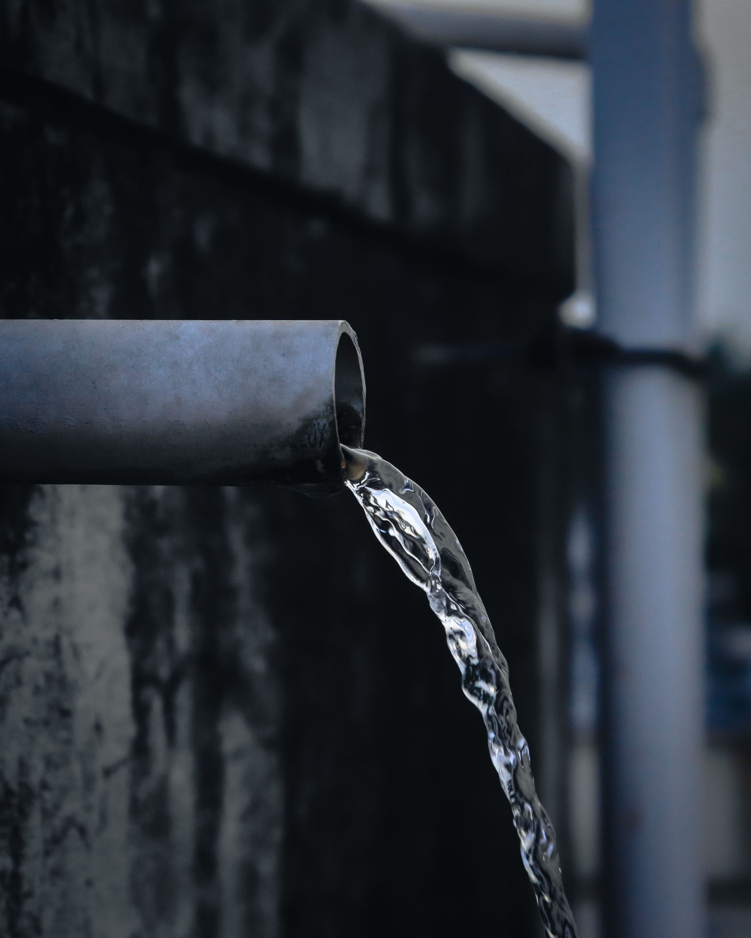 Water pouring from an open pipe outlet
