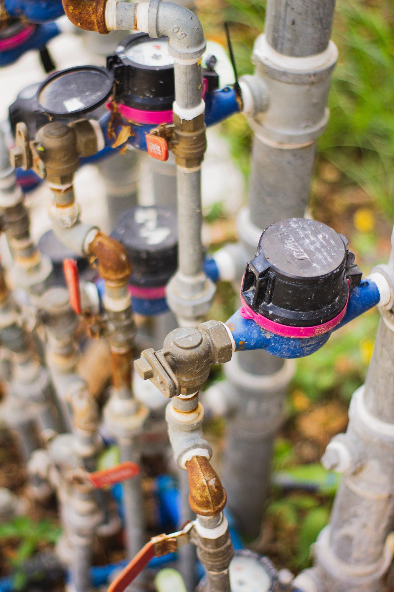 Cluster of brass water meters and valves